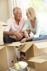 Senior couple packing and downsizing to move to a senior living community